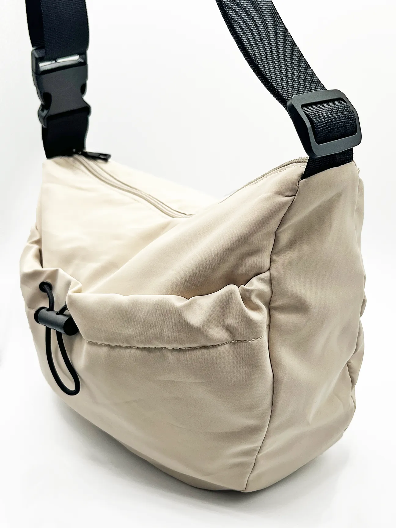 SVNX Nylon sling bag bag with drawstring front pocket in unbleached cotton